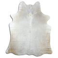 Champagne cowhide rug of about 180 × 150 cm, seen from above: the exact hide you receive