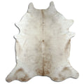 Champagne cowhide rug of about 230 × 210 cm, seen from above: the exact hide you receive