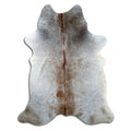 Tan and grey cowhide rug of about 210 × 160 cm, seen from above: the exact hide you receive