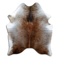 Tan and grey cowhide rug of about 170 × 140 cm, seen from above: the exact hide you receive