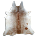 Tan and grey cowhide rug of about 210 × 190 cm, seen from above: the exact hide you receive