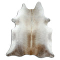 Tan and grey cowhide rug of about 210 × 180 cm, seen from above: the exact hide you receive