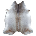 Tan and grey cowhide rug of about 240 × 210 cm, seen from above: the exact hide you receive