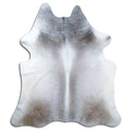 Tan and grey cowhide rug of about 230 × 200 cm, seen from above: the exact hide you receive