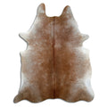 Tan and grey cowhide rug of about 220 × 180 cm, seen from above: the exact hide you receive