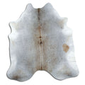 Tan and grey cowhide rug of about 220 × 200 cm, seen from above: the exact hide you receive