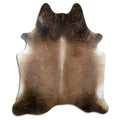 Tan and grey cowhide rug of about 220 × 190 cm, seen from above: the exact hide you receive