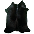 Black cowhide rug of about 190 × 160 cm, seen from above: the exact hide you receive