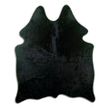 Black cowhide rug of about 190 × 150 cm, seen from above: the exact hide you receive