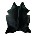 Black cowhide rug of about 200 × 160 cm, seen from above: the exact hide you receive