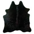 Black cowhide rug of about 180 × 160 cm, seen from above: the exact hide you receive