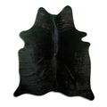 Black cowhide rug of about 170 × 150 cm, seen from above: the exact hide you receive