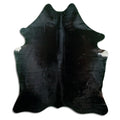 Black cowhide rug of about 190 × 160 cm, seen from above: the exact hide you receive