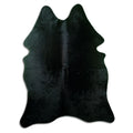 Black cowhide rug of about 190 × 150 cm, seen from above: the exact hide you receive