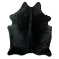 Black cowhide rug of about 190 × 150 cm, seen from above: the exact hide you receive