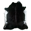 Black cowhide rug of about 210 × 180 cm, seen from above: the exact hide you receive