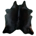 Black cowhide rug of about 220 × 200 cm, seen from above: the exact hide you receive