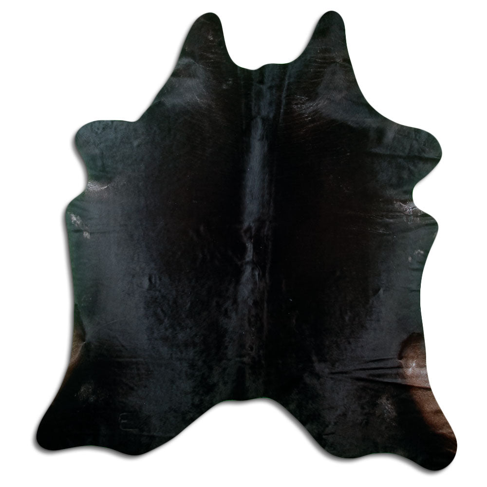 Black cowhide rug of about 220 × 200 cm, seen from above: the exact hide you receive