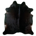 Black cowhide rug of about 200 × 180 cm, seen from above: the exact hide you receive