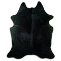 Black cowhide rug of about 220 × 180 cm, seen from above: the exact hide you receive