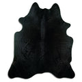 Black cowhide rug of about 220 × 190 cm, seen from above: the exact hide you receive
