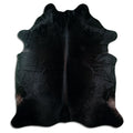 Black cowhide rug of about 220 × 200 cm, seen from above: the exact hide you receive