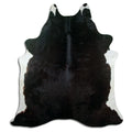 Black cowhide rug of about 210 × 190 cm, seen from above: the exact hide you receive