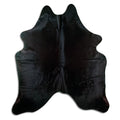 Black cowhide rug of about 220 × 190 cm, seen from above: the exact hide you receive