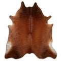 Brown cowhide rug of about 230 × 200 cm, seen from above: the exact hide you receive