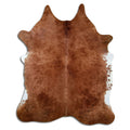 Brown cowhide rug of about 220 × 180 cm, seen from above: the exact hide you receive