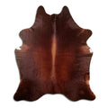 Brown cowhide rug of about 210 × 180 cm, seen from above: the exact hide you receive