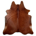Brown cowhide rug of about 220 × 190 cm, seen from above: the exact hide you receive