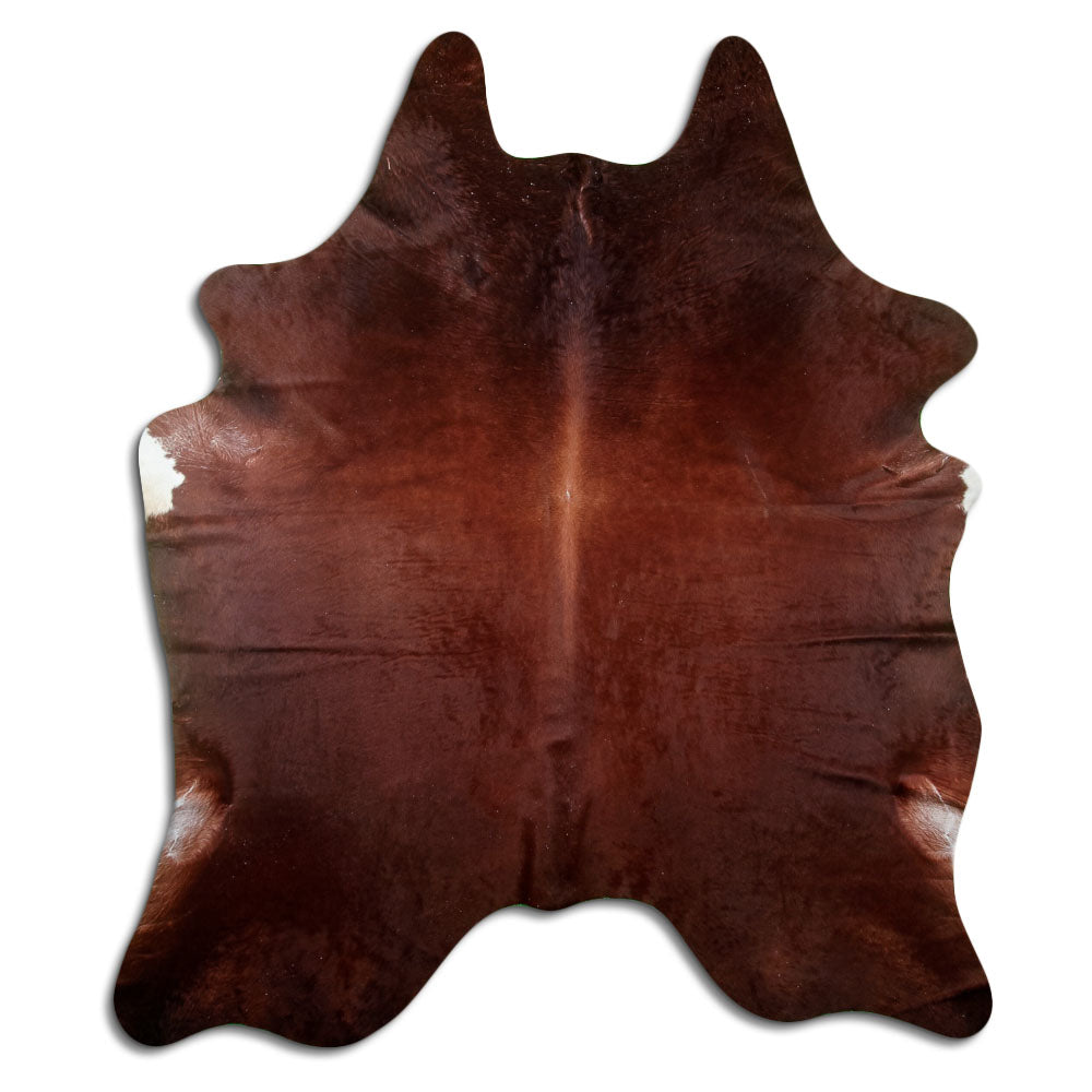 Brown cowhide rug of about 230 × 200 cm, seen from above: the exact hide you receive