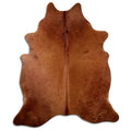 Brown cowhide rug of about 210 × 180 cm, seen from above: the exact hide you receive