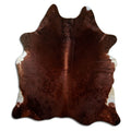 Brown cowhide rug of about 210 × 190 cm, seen from above: the exact hide you receive