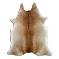 Brown cowhide rug of about 220 × 190 cm, seen from above: the exact hide you receive