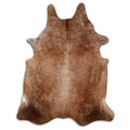Brown cowhide rug of about 240 × 190 cm, seen from above: the exact hide you receive