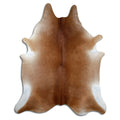Brown cowhide rug of about 230 × 190 cm, seen from above: the exact hide you receive