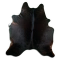 Brown cowhide rug of about 220 × 200 cm, seen from above: the exact hide you receive