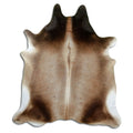 Brown cowhide rug of about 210 × 190 cm, seen from above: the exact hide you receive