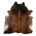 Brown cowhide rug of about 200 × 180 cm, seen from above: the exact hide you receive