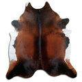 Brown cowhide rug of about 240 × 220 cm, seen from above: the exact hide you receive