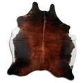 Brown cowhide rug of about 210 × 180 cm, seen from above: the exact hide you receive