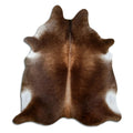 Brown cowhide rug of about 210 × 190 cm, seen from above: the exact hide you receive