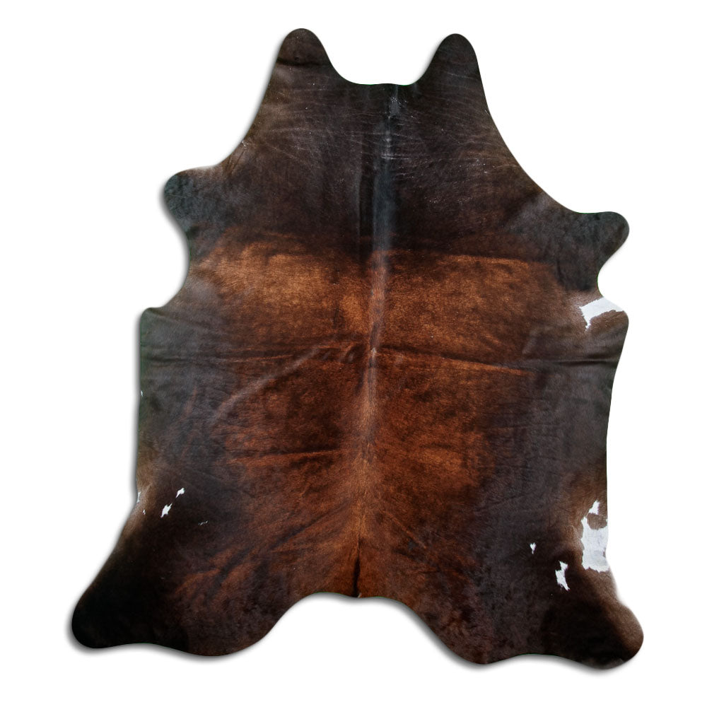 Brown cowhide rug of about 220 × 200 cm, seen from above: the exact hide you receive