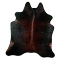 Brown cowhide rug of about 200 × 180 cm, seen from above: the exact hide you receive