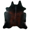 Brown cowhide rug of about 210 × 180 cm, seen from above: the exact hide you receive