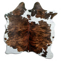 Tricolour cowhide rug of about 160 × 140 cm, seen from above: the exact hide you receive