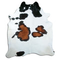 Tricolour cowhide rug of about 230 × 200 cm, seen from above: the exact hide you receive