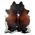 Tricolour cowhide rug of about 220 × 180 cm, seen from above: the exact hide you receive